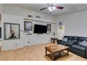 Spacious living room featuring a large TV, leather sofa, and coffee table at 4690 E Utah Ave, Las Vegas, NV 89104