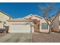 Light pink house with a white garage door and a tree in the front yard at 3456 Beca Faith Dr, North Las Vegas, NV 89032