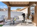 Covered patio with comfortable seating and outdoor grill for delightful gatherings and relaxation at 175 Enloe St, Henderson, NV 89074