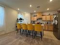 Modern kitchen with light wood cabinets, stainless steel appliances, and a large island at 2609 Via Napoli, Henderson, NV 89044