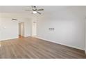 Bright living room with wood-look floors and ceiling fan at 412 Vassar Ln, Las Vegas, NV 89107