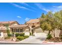 Charming two-story home with a three-car garage, tile roof, and manicured landscaping at 1590 Sabatini Dr, Henderson, NV 89052