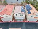 Aerial view displaying the property's roof, solar panels, and positioning on a street with similar homes at 3023 Sunset Harbor Ct, North Las Vegas, NV 89031