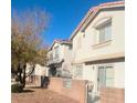 A row of two-story homes with neutral paint and a well-kept exterior, under a clear blue sky at 3023 Sunset Harbor Ct, North Las Vegas, NV 89031