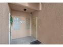 Condo building entry with doors to units 106 and 107 at 5751 E Hacienda Ave # 107, Las Vegas, NV 89122