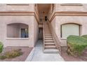 Exterior condo entry with stairs leading to second floor at 5751 E Hacienda Ave # 107, Las Vegas, NV 89122