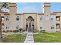Exterior of tan apartment building featuring arched windows and stairs to the second floor at 3145 E Flamingo Rd # 1045, Las Vegas, NV 89121