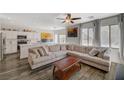 Spacious living room featuring a large sectional sofa, ceiling fan, and access to an open kitchen at 4727 Sweeping Glen St, Las Vegas, NV 89129