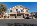 Tan two-story townhome with three-car garage and balcony at 2050 Scanlon Ferry Ct # 103, Las Vegas, NV 89156