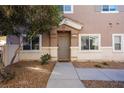 Townhome entrance with a brown door and walkway at 2050 Scanlon Ferry Ct # 103, Las Vegas, NV 89156