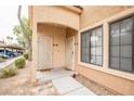 Close up of condo front door with tan stucco and covered parking view at 2151 Hussium Hills St # 207, Las Vegas, NV 89108