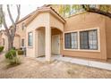 Inviting two-story condo with an arched entryway and desert landscaping at 2151 Hussium Hills St # 207, Las Vegas, NV 89108