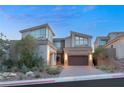 Modern home's exterior boasts a sleek design and landscaped front yard at 31 Vista Outlook St, Henderson, NV 89011