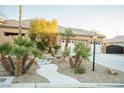 House exterior with a curved walkway and palm trees at 5527 Breecher Ave, Las Vegas, NV 89131