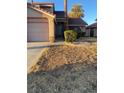 Residential home with a well manicured lawn, a two-car garage, and attractive front yard landscaping at 414 Ackerman Ln, Henderson, NV 89014