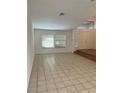 Bright and airy living room with tile flooring, large windows, and a welcoming entryway at 414 Ackerman Ln, Henderson, NV 89014