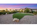 Landscaped front yard with artificial turf and stone accents at 4160 W Ford Ave, Las Vegas, NV 89139