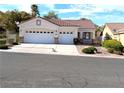 Traditional one story home with a two car garage and concrete driveway at 9728 Echo Hills Dr, Las Vegas, NV 89134