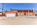 Two-story house with attached garage and terracotta exterior at 1818 Waldman Ave, Las Vegas, NV 89102