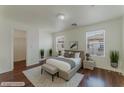 Bright bedroom with large windows, neutral decor, and comfortable furnishings at 6485 Arrow Cottage Ct, Las Vegas, NV 89130