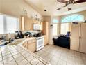 Bright kitchen features ample cabinetry and tile countertops at 3340 N Campbell Rd, Las Vegas, NV 89129