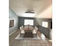 Well-lit dining room with tile floor and a table with seating for six at 4900 Quinlan Ave, Las Vegas, NV 89130