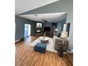 Open concept living room with hardwood flooring, a fireplace, and a ceiling fan at 4900 Quinlan Ave, Las Vegas, NV 89130