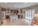 Modern kitchen with an island, stainless steel appliances, and granite countertops at 9113 Sea Mink Ave, Las Vegas, NV 89149