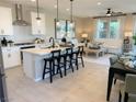 Open concept kitchen with island, stainless steel appliances, and white cabinets at 114 Antler Square Ln, Henderson, NV 89011