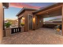 Brick paved courtyard with covered patio and access to garage at 16 Via Stefano, Henderson, NV 89011