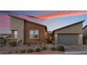 Modern two-story home with a two-car garage and desert landscaping at 16 Via Stefano, Henderson, NV 89011