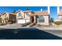 Two-story house with a two-car garage and nicely landscaped front yard at 2412 Eagleridge Dr, Henderson, NV 89074