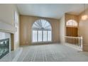 Spacious living room with a fireplace and large window at 2412 Eagleridge Dr, Henderson, NV 89074