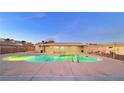 Community pool with a surrounding patio and lights at 4950 Larkspur St, Las Vegas, NV 89120