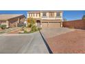 Two-story house with solar panels, three-car garage, and landscaped yard at 5728 Collier Falls Ave, Las Vegas, NV 89139