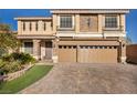 Two-story house with a two car garage and landscaped yard at 5728 Collier Falls Ave, Las Vegas, NV 89139