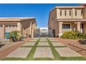 Landscaped front yard with paver driveway and RV gate at 5728 Collier Falls Ave, Las Vegas, NV 89139