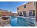 Large rectangular pool with a spacious patio and fire pit features at 5728 Collier Falls Ave, Las Vegas, NV 89139