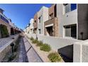 Pathway through a community of modern townhomes with landscaping at 600 N Carriage Hill Dr # 1113, Las Vegas, NV 89138