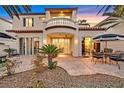 Relaxing backyard patio with an outdoor dining set and lush desert landscaping at 8390 Carmel Ridge Ct, Las Vegas, NV 89113