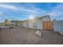 Side view of home highlighting a wooden fence and desert landscaping at 230 Ash St, Henderson, NV 89015