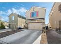 Two-story house with beige siding, a two-car garage, and a small yard at 6271 Port Astoria Ct, Las Vegas, NV 89122