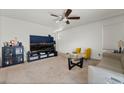 Living room featuring a large TV, comfortable seating, and a coffee table at 6271 Port Astoria Ct, Las Vegas, NV 89122