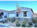 Gray single-story house with a two-car garage and drought-tolerant landscaping at 32 Honeymoon Dr, Henderson, NV 89011