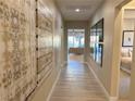 Bright hallway with light wood floors and artwork at 36 Honeymoon Dr, Henderson, NV 89011