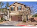 Charming two-story home with a brown garage door, neat landscaping, and a paved driveway at 6482 Twin Harbors Ct, Las Vegas, NV 89141