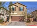 Charming two-story home with a brown garage door, neat landscaping, and a brick paved driveway at 6482 Twin Harbors Ct, Las Vegas, NV 89141