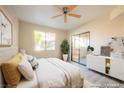 Sunlit bedroom with a sliding glass door and a neutral color scheme at 8455 W Sahara Ave # 154, Las Vegas, NV 89117