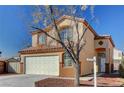 Charming two-story home with desert landscaping, tile roof, and a two-car garage at 3691 Springbud Dr, Las Vegas, NV 89147