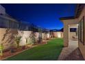 Landscaped backyard with artificial turf and patio at 144 Juliette Pointe Ln, Henderson, NV 89011